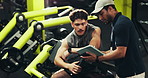 Men, personal trainer and tablet with machine for workout routine, training or exercise schedule at gym. Male people, fitness instructor or coach with technology or checklist for health goals or app