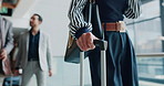 Hands, luggage and travel with business woman at conference for B2b manager, seminar speaker and hotel. Convention center, walking and suitcase with person in lobby for showcase event and expo