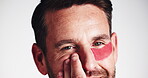 Beauty, eye mask and face of happy man in studio for antiaging, dermatology or moisturizing routine. Cosmetics, hydration and skincare with person on gray background for aesthetic or wellness