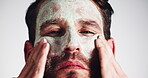 Man, skincare and happy with face mask application for deep cleansing, skin routine and anti aging treatment. Cosmetics, person and organic product for hydration and exfoliation on studio background