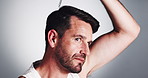Man, hairline and oil with dropper for scalp condition, hair growth or treatment on a white studio background. Male person, model or applying serum with pipette for dry, alopecia or texture on space