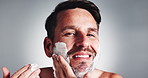 Happy man, face and skincare with cream in studio for moisturizer on a white background. Portrait, male person or model with smile, lotion or beard aftershave for epilation, grooming or spa facial