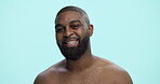 Smile, beauty and face with black man in studio for skincare cosmetics, dermatology and self care. Clean, glow and male grooming with person on blue background for hydration, collagen and shine