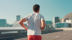 Running, athlete and fitness on road, man and exercise for sports in city, back and healthy for cardio. Outdoor, runner and training for marathon on urban street, workout and wellness for speed