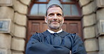 Face, smile and man for judge in city for career confidence, urban justice and court recess. Portrait, mature lawyer and arms crossed of trial process, legal procedure and authority for case hearing