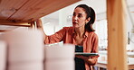 Pottery, shop owner and woman with tablet to check quality, inventory and design in store. Startup business, ceramic warehouse and tech with online order, stock or invoice by shelf for product