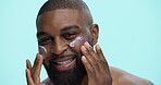Cream, moisturizer and beauty with face of black man in studio for cosmetics, dermatology or self care. Lotion, skincare and grooming with person on blue background for hydration, collagen and facial