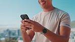Man, hands and typing with phone for fitness app, chatting or texting on mountain view. Closeup, male person or user with smile or smart watch on mobile smartphone for health tracker or social media