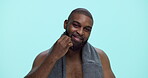 Face, grooming and man with beard, comb and tangle prevention with tool, smile and morning in styling. Blue background, studio and black person with routine for hygiene, space and facial treatment