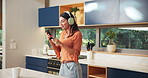 Dancing, headphones and woman with phone in kitchen with spoon for music, fun or entertainment. Energy, cellphone and female person moving with audio tech for playlist, album or radio online in home.