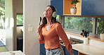 Dance, headphones and woman singing in kitchen with spoon for music, fun or entertainment. Energy, karaoke and female person moving with audio tech for playlist, album or radio online in home.