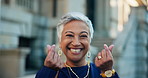 Mature, happy woman and face with finger heart emoji in city for love, care or share. Portrait, female person or smile with joy, icon or hand gesture for expression, kindness or gratitude in town