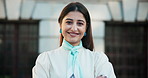 Face, smile and business woman in city with confidence for career in real estate, property investment and pride. Portrait, arms crossed and happy professional outdoor with realtor or worker in Spain
