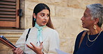 Women, lawyer or walking with documents for testimony, court justice or proposal in city. Female people, attorney or talking with paperwork for legal law or case preparation together in an urban town
