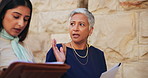 Women, lawyer or discussion with documents for testimony, court justice or proposal in city. Female people, attorney or talking with assistant or paperwork for legal case preparation in an urban town
