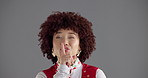 Woman, finger and silence in studio with face, vintage style or secret in disco costume by background. Girl, person and sign for privacy, party and fashion for retro event with portrait in Costa Rica