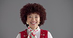 Happy woman, face and fashion with afro in studio for retro or vintage clothing on a gray background. Portrait, female person or model with smile or curly hairstyle in stylish outfit on mockup space