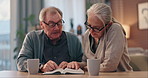 Old couple, bible and reading together in home, study religion or faith bonding for Christianity in retirement. Senior people, coffee and holy book for scripture, gospel and spiritual relationship
