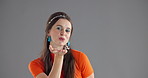 Blowing kiss, beauty and face of woman in studio with cosmetics, laughing and smile. Fashion, mockup space and portrait of happy person with love emoji, hand gesture and flirting on gray background