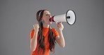 Woman, loudspeaker and shouting in studio with announcement for retro fashion deal by background. Person, bullhorn and voice with fist, audio and noise for info, sale or promotion with vintage style