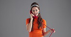 Woman, talking and vintage telephone in studio with smile for gossip, listen and conversation by background. Girl, phone call and happy with connection for chat, contact and story with retro fashion
