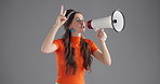 Woman, loudspeaker and shout in studio with voice for human rights, change or stop war by background. Person, bullhorn and audio with fist, peace sign or protest for justice, equality or announcement