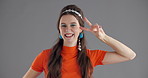 Woman, dancing and face in studio with vintage style, smile and excited for disco by background. Girl, person and laughing in portrait with peace sign, fashion and retro event with costume in USA