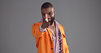 Face, black man and point to you in studio for decision, choice and selection of fashion vote. Portrait, male person and hand gesture for invitation, show winner and outfit opinion on gray background