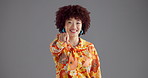 Happy woman, face and pointing to you in studio with fashion for selection on a gray background. Portrait, female person or model with afro, smile or finger gesture for choice or pick on mockup space