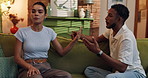Couple, living room and argument with frustrated, stress and drama at home or apartment. Anxiety, woman and man with dispute, angry and fight with toxic marriage and mistake or crisis with partner