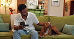 Man, home and smartphone with credit card for dog, pet insurance or purchase with animal ecommerce. Stroke, happy and friendly male person with puppy, mobile banking or online shopping at house