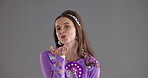 Studio, woman and face with air kiss for blowing, romance and emoji gesture with expression for love. Mockup, female person and smile in portrait for flirting, connection and sign by gray background