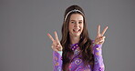 Woman, retro and face with peace sign in studio for aesthetic freedom, trendy style or goofy personality. Vintage, girl or laughing with v hands for fashion support and bold outfit on gray background
