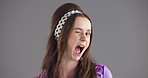 Wink, fashion and face of woman in studio for happiness, confident and trendy style. Mockup space, smile and portrait of person with emoji, gesture and flirt in cool clothes on gray background