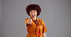 Happy, pointing to you and face of woman in studio for decision, choice and encouragement. Confidence, wink and portrait of person with finger for selection, emoji and gesture on gray background