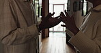 Couple, hallway and hands with argument, stress and drama at home or apartment. Frustrated, woman and man with fight, angry conflict and anxiety with toxic marriage and mistake or crisis with partner
