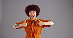 Happy woman, face and studio with thumbs up for thank you, fashion or style on a gray background. Portrait, female person or model with smile, like emoji or peace sign for emotion or expression