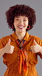 Face, smile and woman with thumbs up in studio for agreement, feedback or success on gray background. African person, portrait and like hand gesture for recommendation, good job or thank you emoji