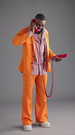 Man, talking and retro telephone in studio with smile for story, gossip and disco style by background. African person, phone call and happy for discussion, contact or laugh at joke in vintage fashion