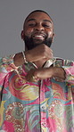 Face, dancing and black man with fashion, retro clothes and energy on gray background. African person, model and vintage outfit with movement, stylish wardrobe and smile with pride,  and colourful