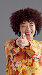 Retro, finger gun and woman with fashion, studio and confident with old school style and happiness. Gray background, face and person with pride for vintage clothes, peace sign and excited in USA