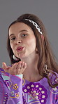 Smile, face and woman blowing kiss in studio with flirting, love or romantic gesture for valentines day. Happy, fashion and portrait of person from London with care or kindness by gray background