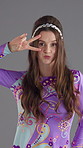 Face, dancing and woman with fashion, vintage clothes and stylish wardrobe on gray background. Happy person, model and retro outfit with energy, trendy and smile with pride, peace sign or colourful