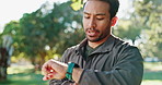 Fitness, running and man check time on watch in nature for warm up, workout and wellness outdoor. Exercise, training and male athlete at park for healthy lifestyle, challenge or tracking goal
