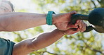 Fitness, kettlebell and hands of man in nature for weightlifting, workout and wellness outdoor. Exercise, training and male athlete at park swing for weight challenge, muscle health or low angle