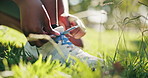 Hands, outdoor and person tying laces for fitness, workout or running in park in nature for health. Closeup, shoes and athlete with sneakers preparing for cardio exercise with marathon training.
