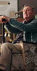 Senior man, cane and reflection on sofa in home, thinking and rest for recovery, stroke and retirement. Elderly person with disability, walking stick and relax with perspective, insight and injury