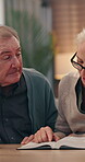 House, elderly and couple reading book for God in spiritual religion for peace, guidance and learning. Senior, retirement or people with literature, scripture and bible with prayer, faith or gospel