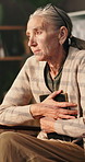 Photograph, sadness and thinking with senior woman in retirement home for loss or nostalgia. Depression, grief or memory and unhappy widow with picture in apartment for loneliness, mistake or regret