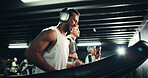 Headphones, sweating and man on treadmill in gym for running, exercise and endurance with fatigue and podcast. Cardio, tired runner and machine for training, intense and radio at fitness center